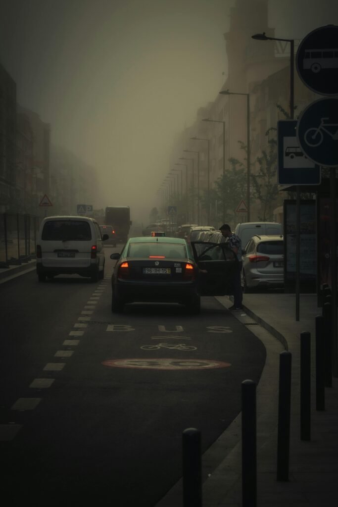 A car on a foggy street in Aveiro, Portugal with a person entering or exiting the vehicle.