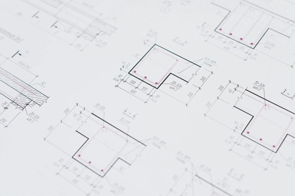 High-resolution close-up of detailed architectural blueprints showcasing precision design layouts.