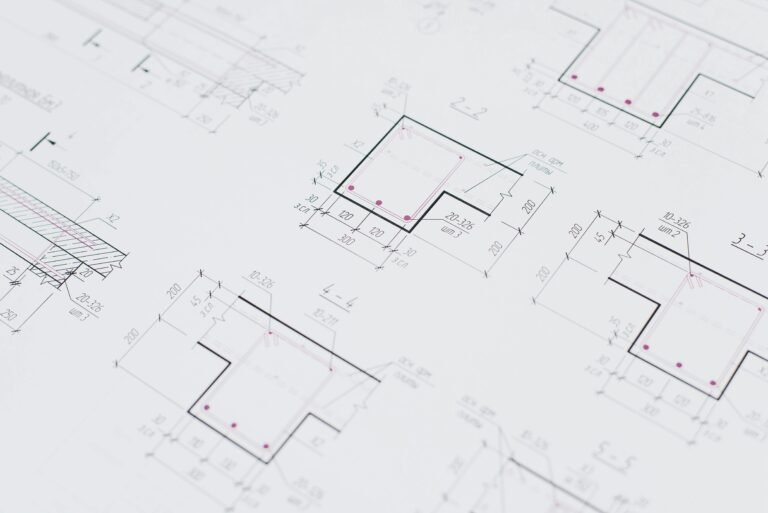 High-resolution close-up of detailed architectural blueprints showcasing precision design layouts.